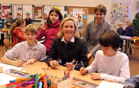 Bettina Wulff mit Schülerinnen und Schülern in einem Klassenzimmer