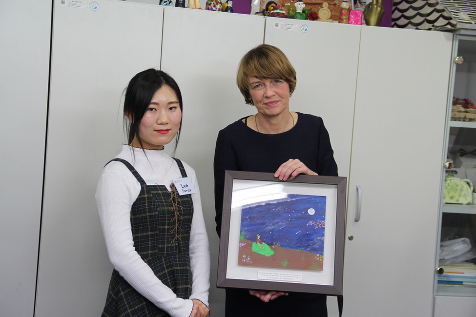 Elke Büdenbender erhält ein Bild und ein Gedicht als Geschenk von einer jungen Nordkoreanerin aus der Yeo-Myong-Schule in Seoul im Rahmen des Antrittsbesuchs des Bundespräsidenten in Südkorea