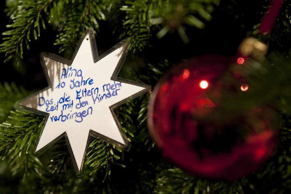 Wünsche von Kindern einer Berliner Schule auf den Sternen am Weihnachtsbaum in Schloss Bellevue