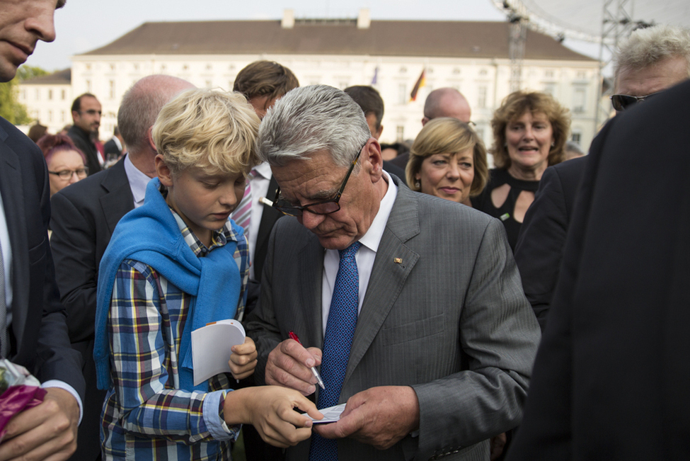Bundespräsident Joachim Gauck mit einem jungen Gast auf dem Bürgerfest des Bundespräsidenten 2013