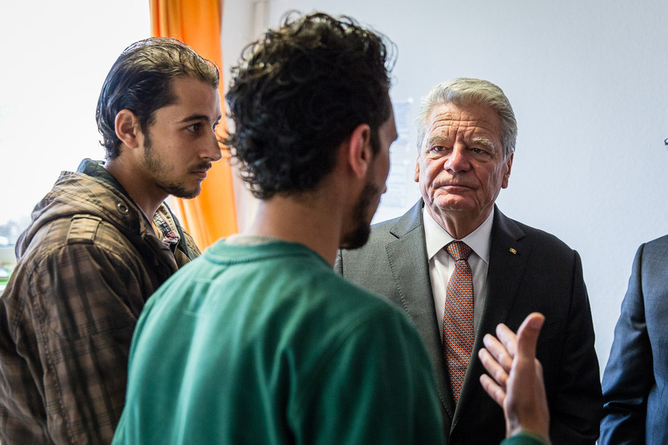 Bundespräsident Joachim Gauck begegnet während seines Besuchs in der Flüchtlingsunterkunft am ehemaligen Bastei-Lübbe Verlagsgebäude in Bergisch Gladbach den syrischen Flüchtlingen Abd Aljasem und Magd Shelukie 